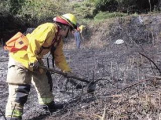 Brush fire threatens two homes