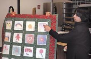 Southwood Elementary fourth grader Harjot Bassi points out the quilt square he designed as part of the class project. Photo by Brenda Sexton