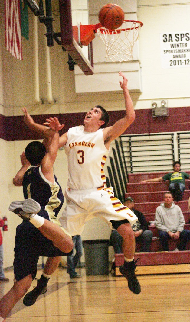 Enumclaw High guard Tony Chynoweth goes  up for a rebound over Jason Young with Decatur.