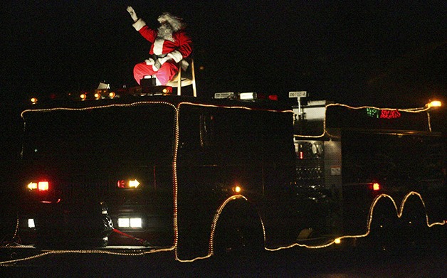 Santa Claus aboard a District 28 fire truck on in Enumclaw Friday