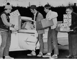 Enumclaw teacher and principal Mike Binetti helps these Key Club officers load gifts into a car in the late 1960s