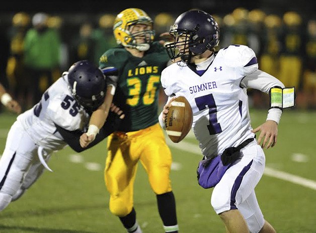 Sumner quarterback Chase Torgison looks for an open receiver Friday against Lynden at Bellingham’s Civic Stadium.