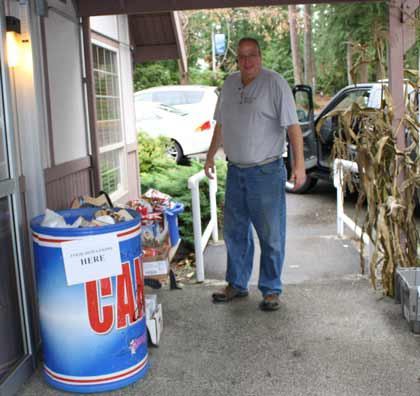 Bonney Lake Food Bank Director Stew Bowen picks up food donated at the Bonney Lake Senior Center Nov. 19. Donations from the seniors