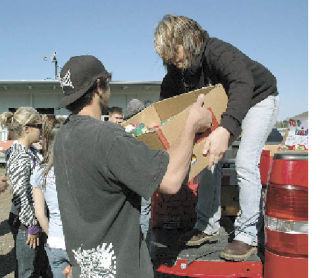 Cameron Cousineau and Hayley Paulsen load up a truck full of donations for the Buckley Kiwanis Food Bank. The Collins High School students couldn’t pinpoint specifically how much food they collected during a recent food drive for the food bank