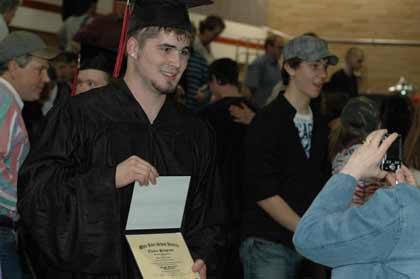 Shane Jackson poses for photos and shows off his Choice diploma after commencement exercises June 7.