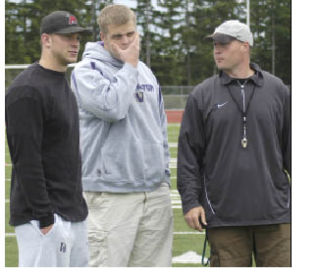 Jake Locker and Cody Habben talk with Bonney Lake High football coach Chad Barrett during last week’s youth football camp.