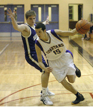 Sumner guard Johnnie Greenwood brings the ball past a Sequim defender during play Dec. 30 at home. The Spartans lost the nonleague contest 59-53.