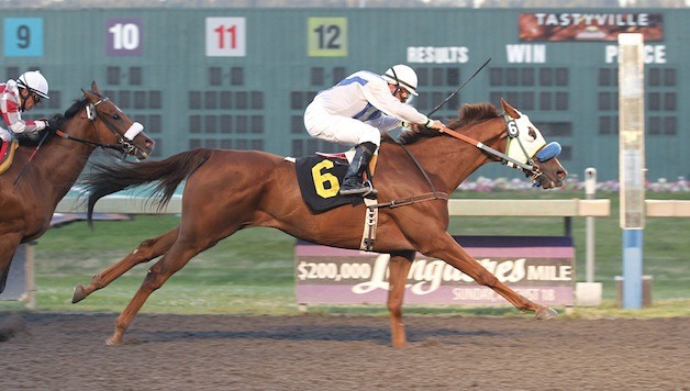 Bill Jensen's 7-year-old gelding Tapadero surges to victory in the feature race for 3-year-olds and up at Emerald Downs on Wednesday