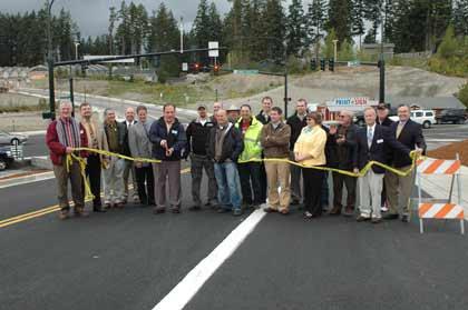 Bonney Lake Mayor Neil Johnson cuts the ribbon on the city's new Main Street during a ceremony April 27.