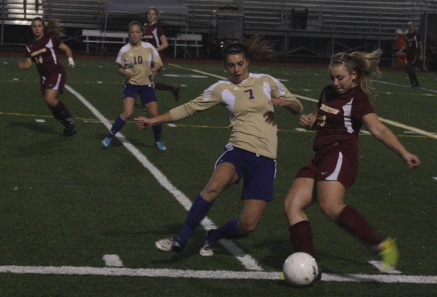 Kaylie Rozell tries to knick the ball from a Kingston player.