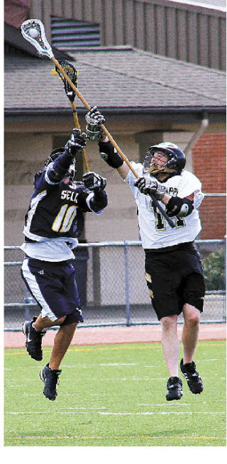 Steven Winters grabs some air and the ball from a Selah player during play this spring.