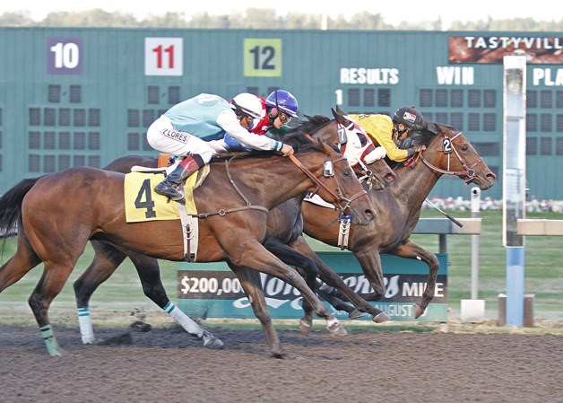 Leslie Mawing surges Grand Baylee (No. 2) past Tullamore Dew in the fifth race at Emerald Downs to give the 38-year-old jockey the 2