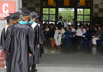 Graduating Panthers wait pensively outside an expo center filled with family and friends before the ceremony begins.