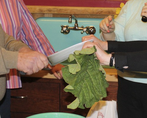 Mayor Dave Enslow and city spokeswoman Carmen Palmer cut a stalk of rhubarb to mark the opening of Sumner's visitor center.