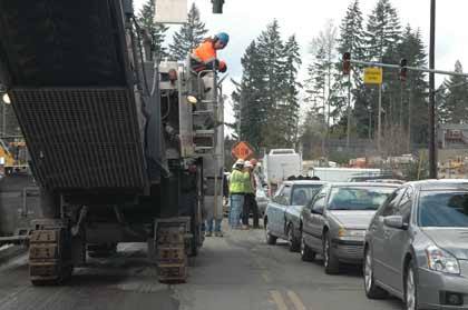 Drivers on Sumner-Buckley Highway pass a grinding machine Thursday. Construction on the roadway is scheduled to be completed next week