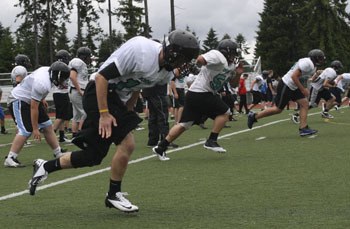 The Panthers varsity squad runs wind sprints during an off-season practice session.