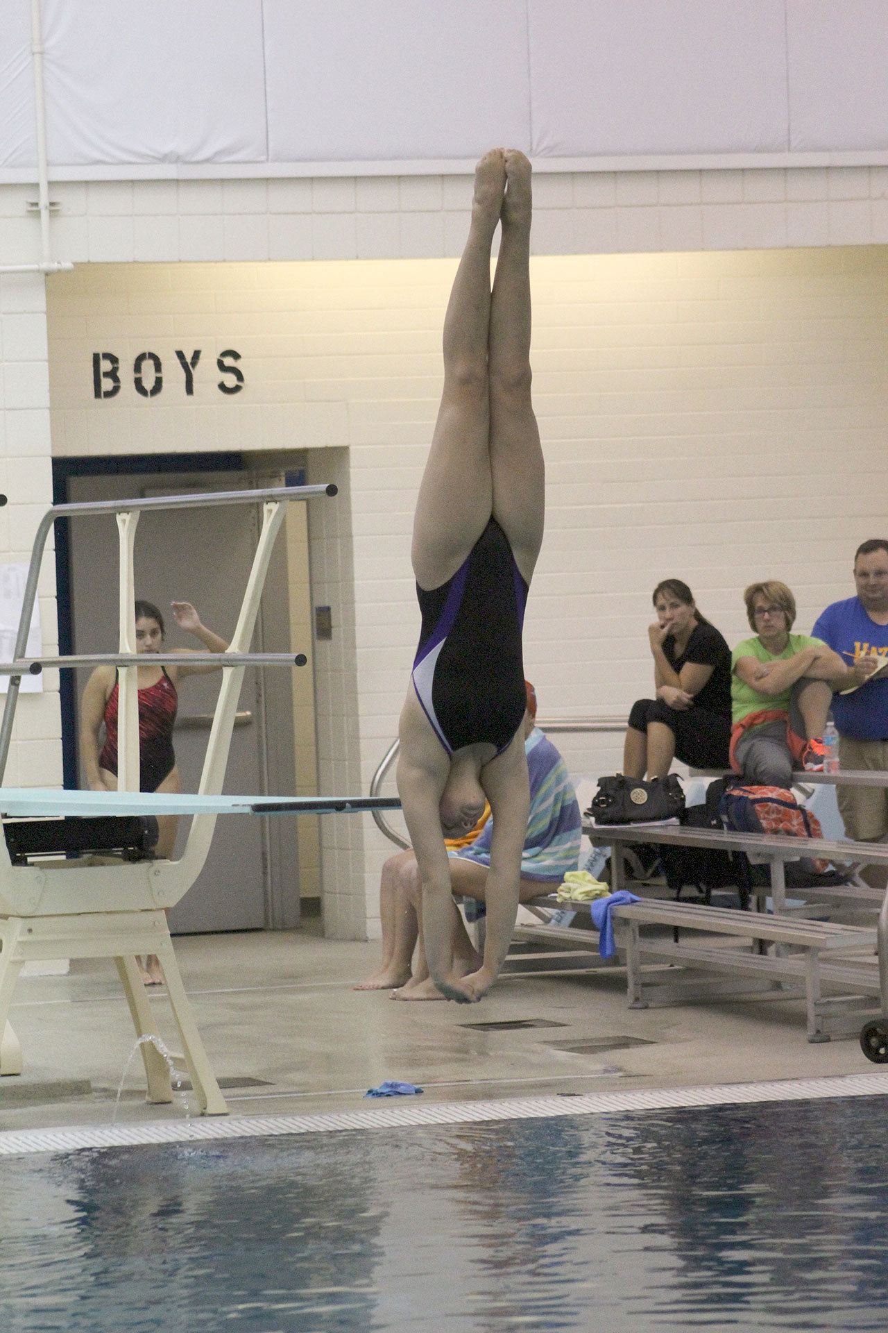 McKenna Webster completes a dive during the district competition at Curtis High School. Photo by Ray Still.