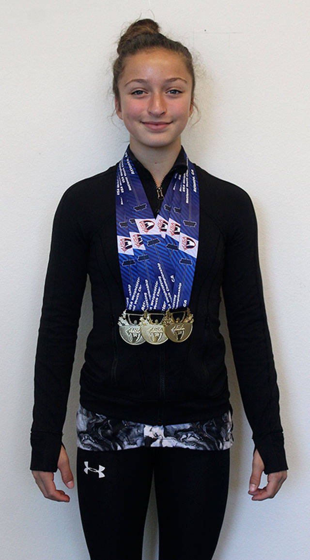 Noelle Toro-Strickling wearing the three gold medals she earned at the last national competition. Photo by Ray Still