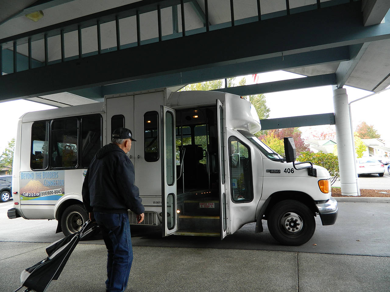 A senior boards the Beyond the Borders Connector Bus at the Sumner Senior Center. The bus route will soon include going up the hill into Bonney Lake. Photo by Pierce County Transportation Services