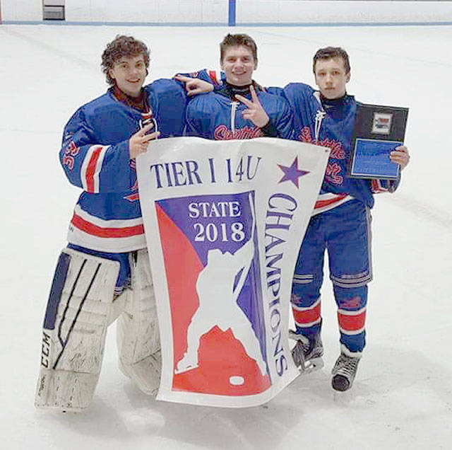 Holding their championship banner are, from left, goalie Andy Vlaha and Plateau players Andrew Alonzo and Danny McCarragher. Photo courtesy Jeff Alonzo.