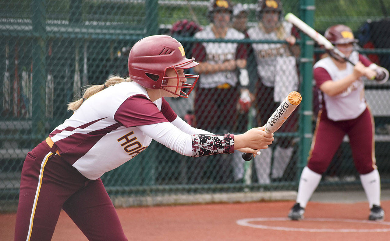 White River senior Noelle Mills prepares to drop a bunt during Friday’s district contest against Olympic. Photo by Kevin Hanson