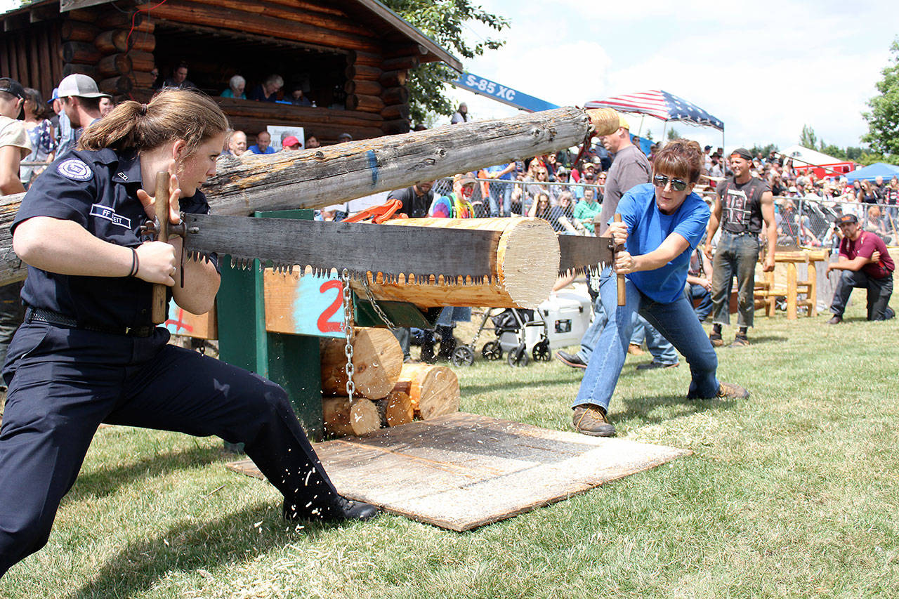 Sandy Burkett,right, shows off her strength when she competed in the 2018 Buckley Log Show. Photo by Ray Miller-Still