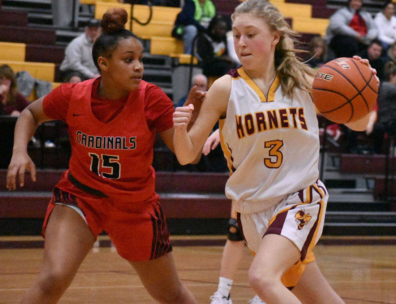 The White River High School girls opened the South Puget Sound League 2A tournament Feb. 5 with a convincing 66-37 victory over the Franklin Pierce Cardinals. Above, Hornet junior Lucy Starkel drives to the hoop. Photo by Kevin Hanson