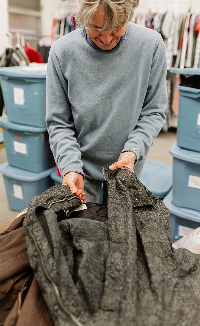 A longtime volunteer sorts through clothing donations at the Donald Loomis Memorial Clothing Bank. Photo courtesy Emma Morem