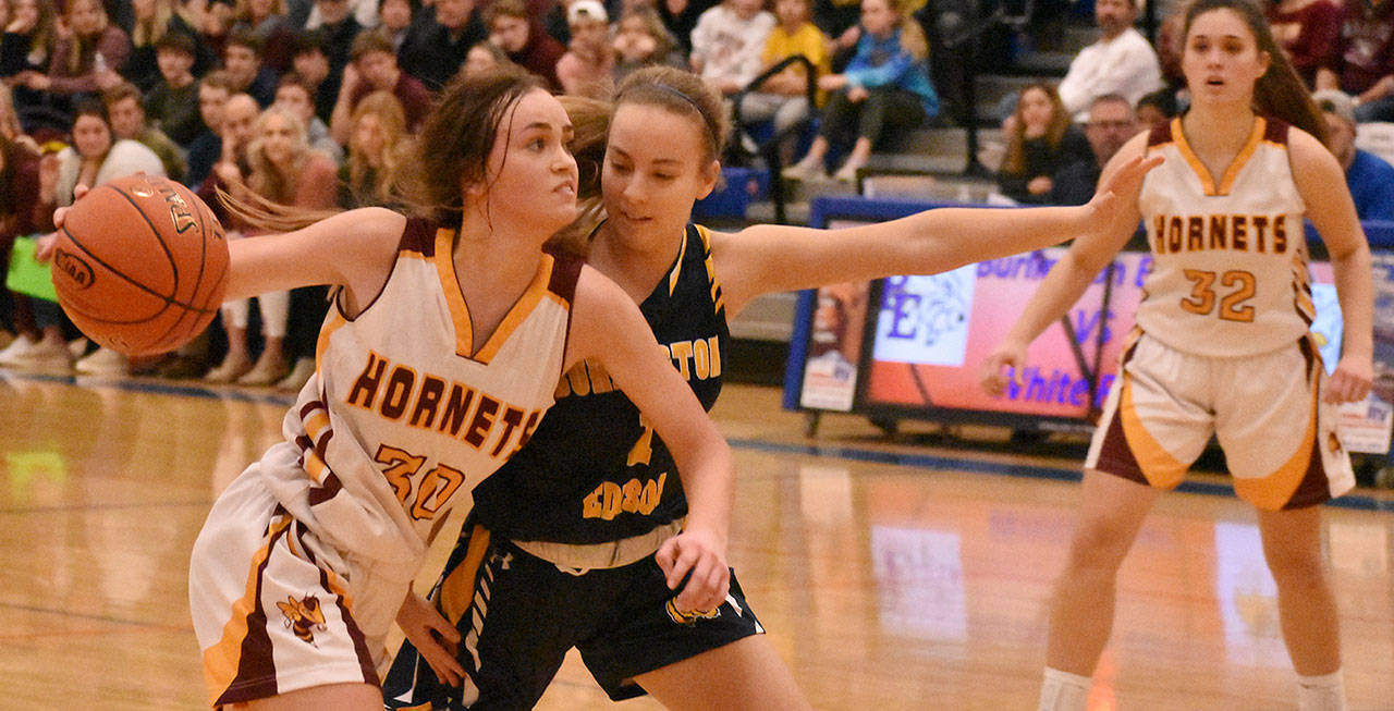 Rylie Lund tries to run past a Burlington opponent during the state regional tournament to qualify for state. Photo by Kevin Hanson