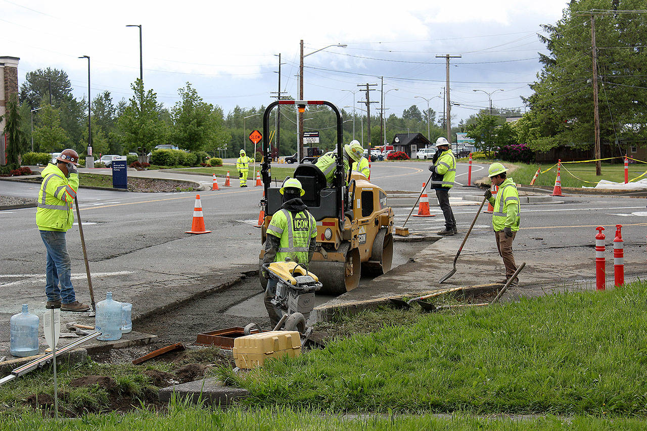 In Enumclaw, road crews are busy helping navigate traffic on Cole St. and Warner Ave. Photo by Ray Miller-Still