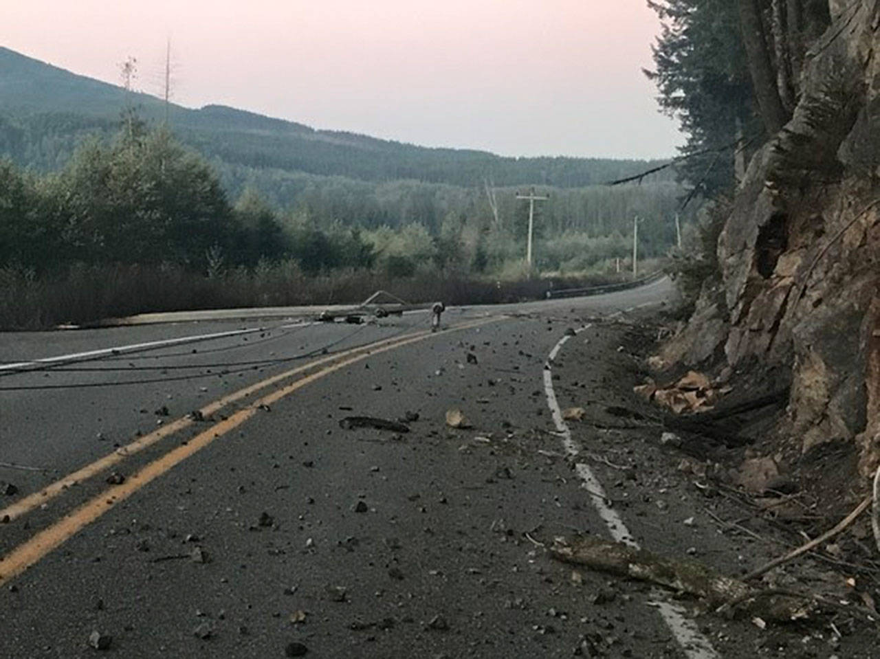 Downed power lines and loose rocks normally held by tree roots keep the highway east of Enumclaw unsafe for drivers. Image courtesy Department of Transportation