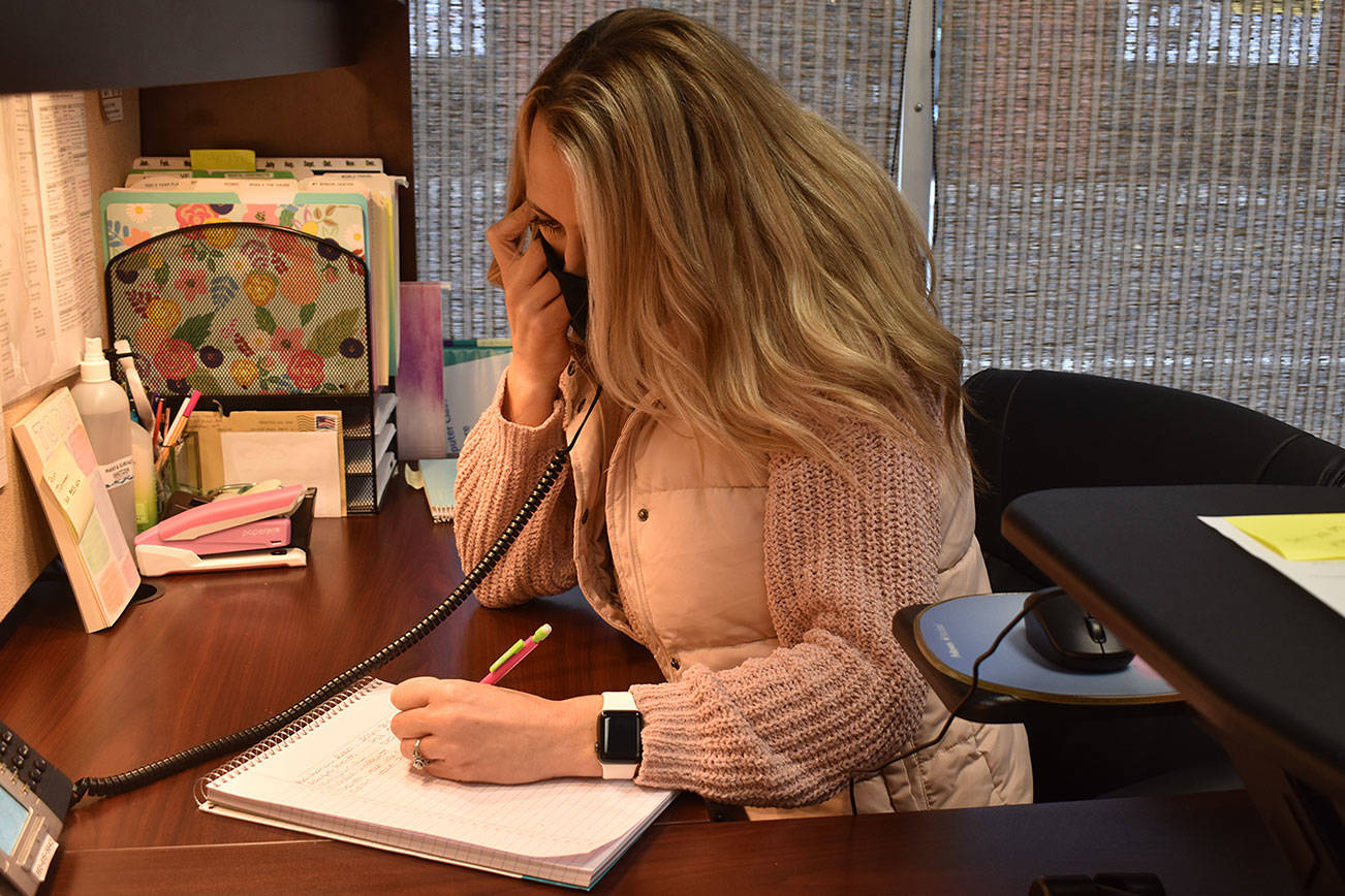 Melissa Holt, recreation programmer at the Senior Activity Center, answers voicemails Tuesday morning from people hoping to get vaccinated on Sunday. Photo by Alex Bruell