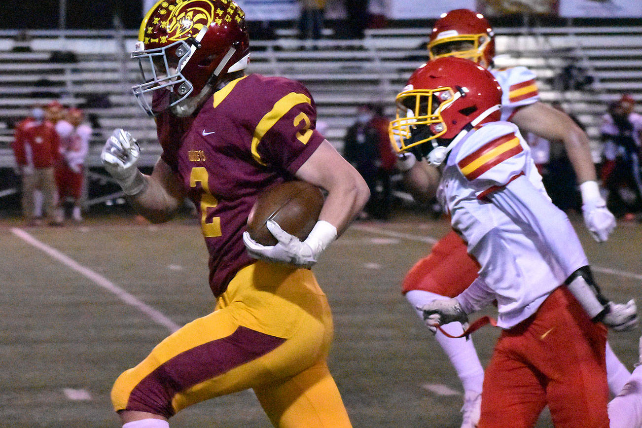 Enumclaw High's Royal Snyder outruns Mount Tahoma defenders during the early stages of Friday night's lopsided Hornet victory. Photo by Kevin Hanson