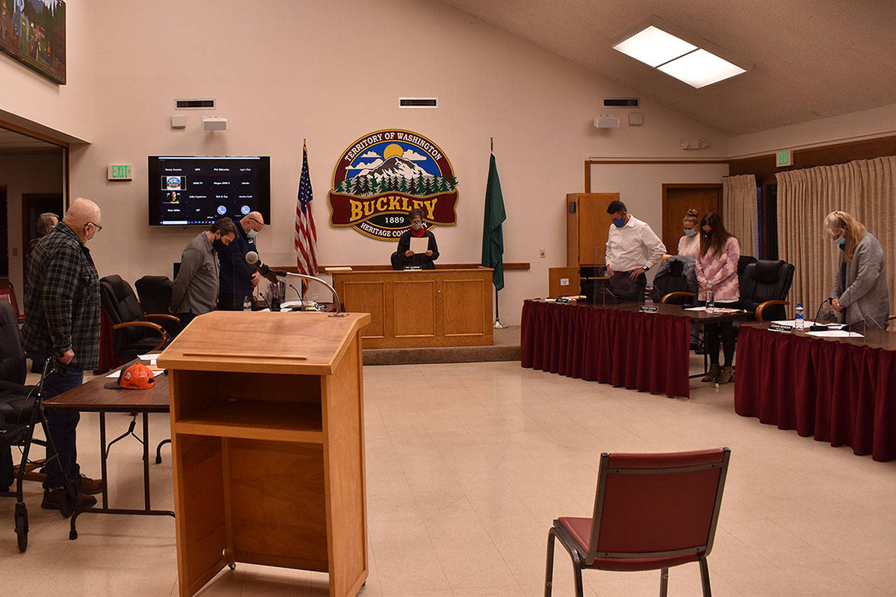 Buckley Mayor Pat Johnson, center, reads a proclamation during the Tuesday evening Buckley City Council meeting committing herself and the council to promoting education and services for the use of helmets in honor of Berrett Wirth Crossley, who died earlier this month after sustaining a head injury while skateboarding without a helmet. Council members in attendance stood during the reading of the proclamation. Photo by Alex Bruell