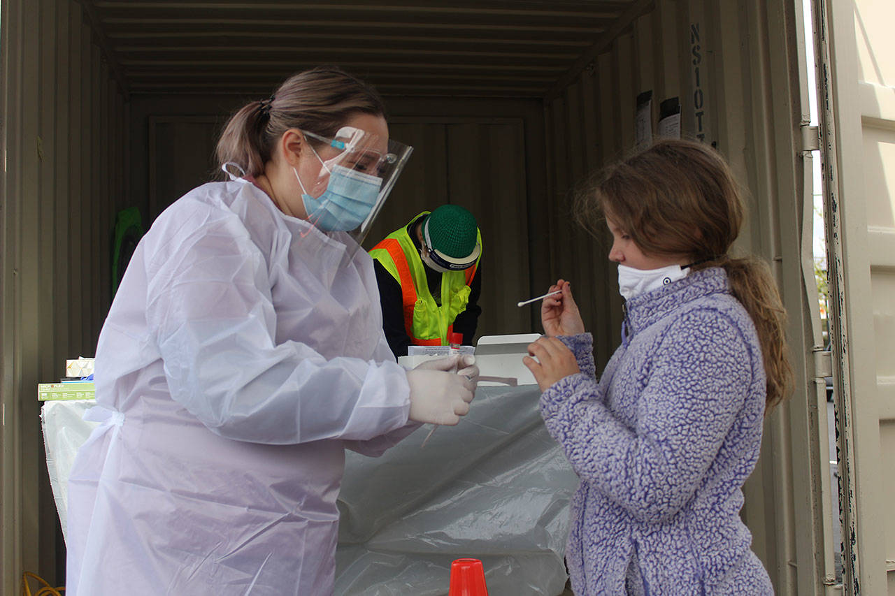 Emma Miller testing herself for coronavirus at the Enumclaw testing site. Photo by Ray Miller-Still