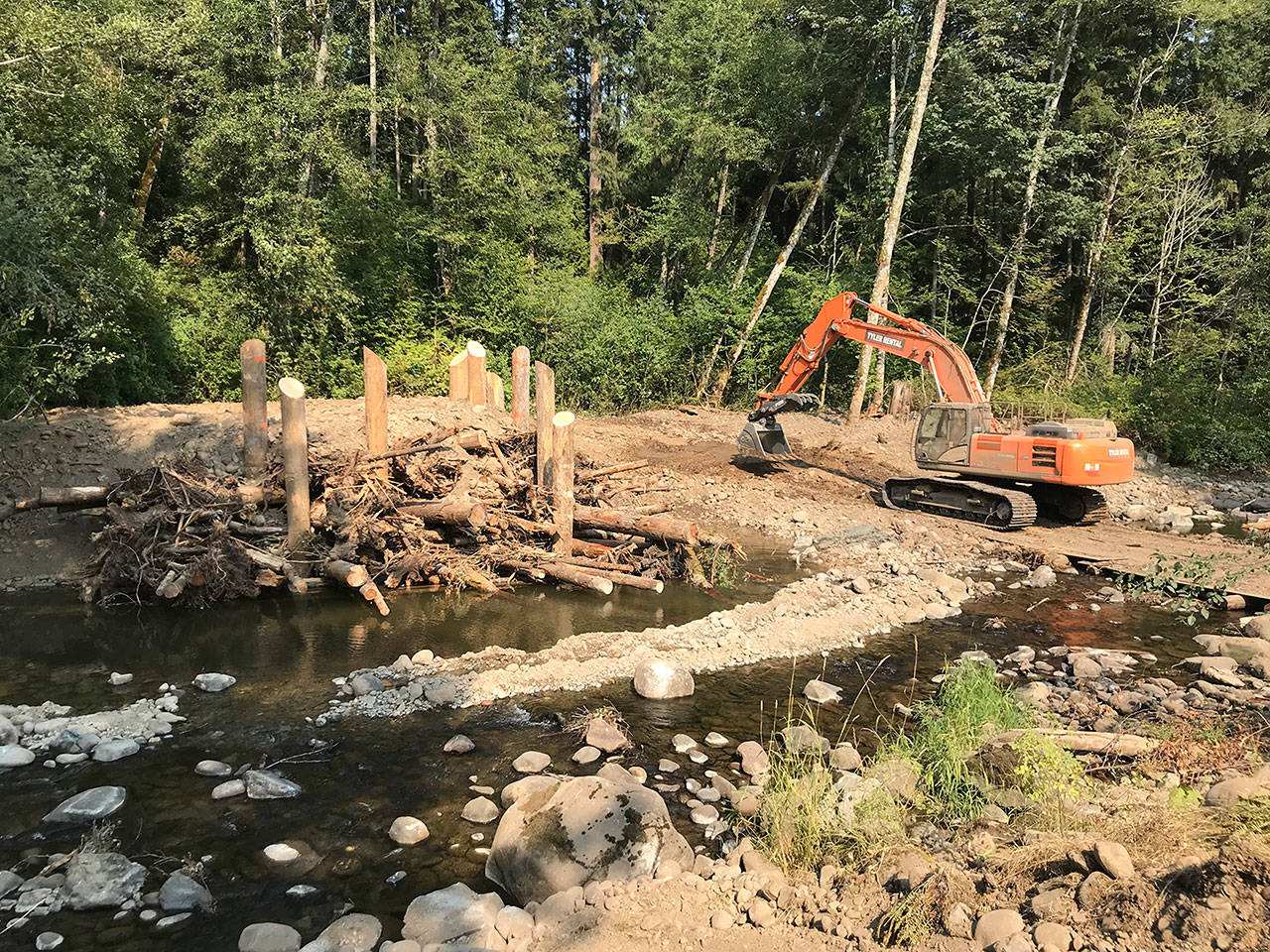 An excavator adds the finishing touches to an engineered logjam. Photo courtesy the South Puget Sound Salmon Enhancement Group