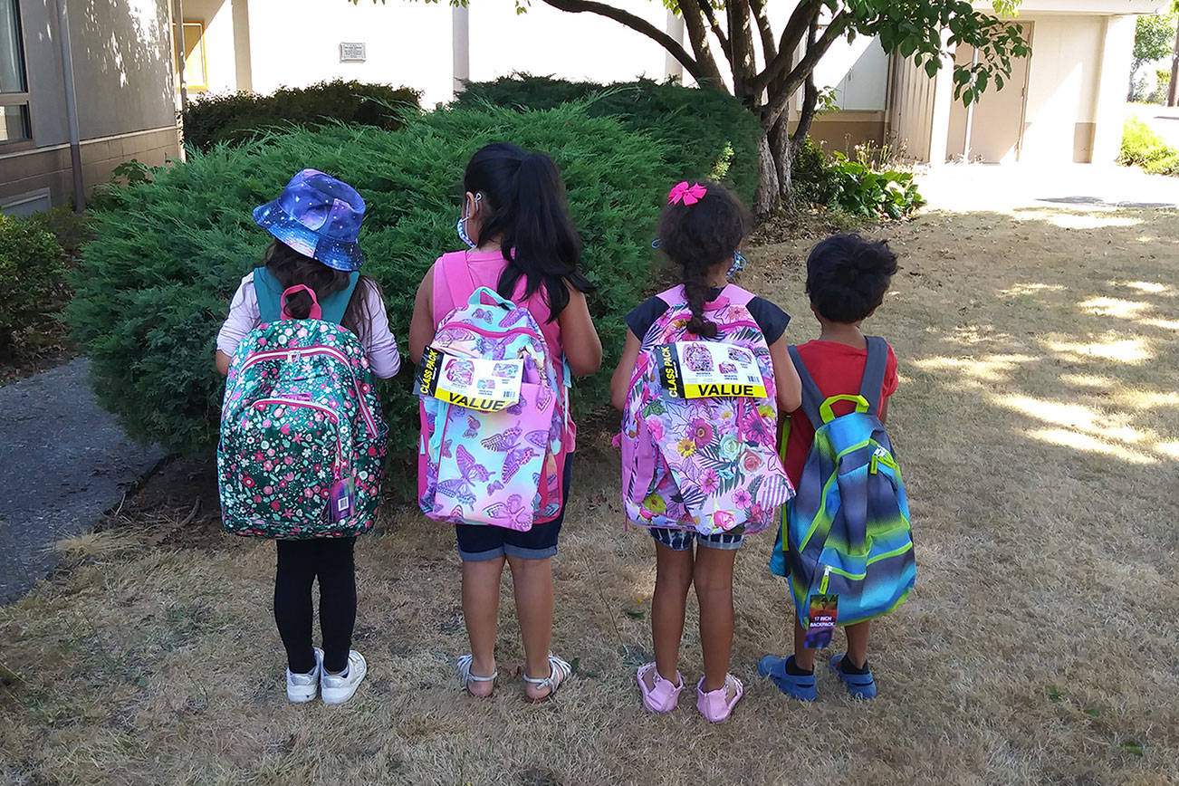 A group of kids shows off backpacks from the Y Social Impact Center’s school supplies drive. Photo provided by Y Center Office Manager Christine Adkins.