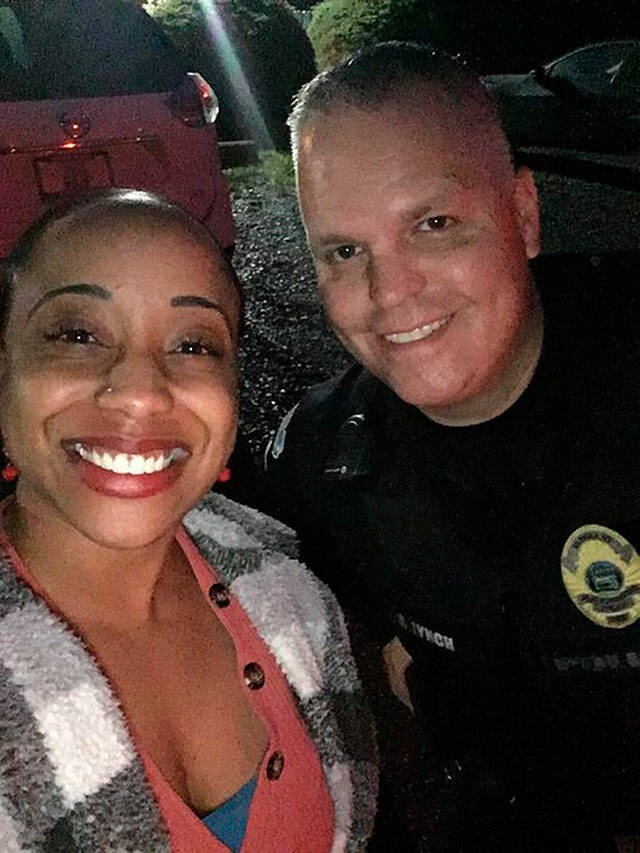 Sientje Morris and Black Diamond Sgt. Brian Lynch during a recent traffic stop where Lynch helped Morris get her car towed and repaired — all at no cost to her. Photo courtesy Black Diamond Police Department