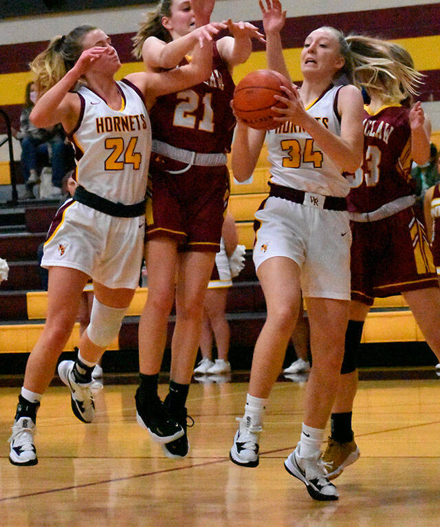 It was a Hornet-Hornet battle for a rebound Friday night when the girls’ teams from White River and Enumclaw met in Buckley. Coming away with the ball is White River freshman Vivian Kingston; also in the scramble are teammate Josie Jacobs and Enumclaw’s Bella Firnkoess (21). Photo by Kevin Hanson