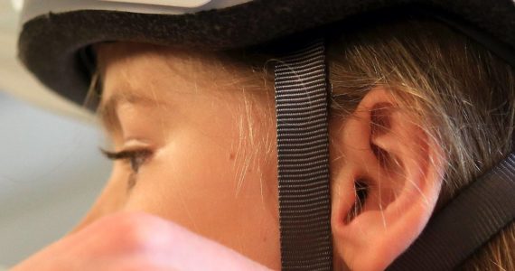 Cadence Patton, 9, gets properly fitted for a bike helmet at Bayside Bikes in Everett on June 17, 2016. Sound Publishing file photo