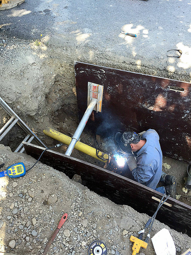 Enumclaw welder Nick Burden improving the gas line underneath Warner Avenue. Photo courtesy the city of Enumclaw