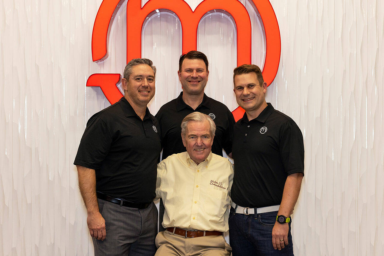 Bruce Molen, front, started Molen Orthodontics in Auburn March 1972. His sons, Rick, center back, and Aaron, right, joined the practice in the 2000s, while Rick’s schoolmate Chris became a part of the team in 2016. Photo by Heather Boren / <a href="http://www.heatherborenphotography.pic-time.com" target="_blank">heatherborenphotography.pic-time.com </a>