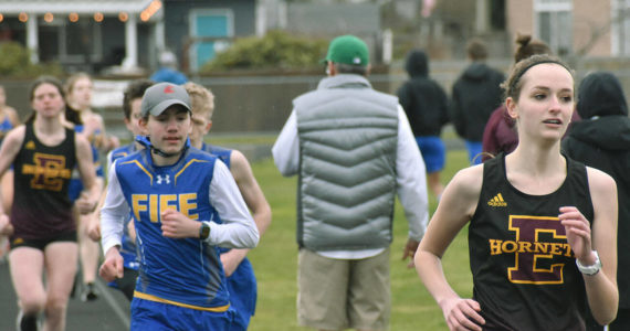 Ava Sawyer, right, and Lindsay Essex, far left, posted first and second place showings, respectively, in the girl's 1600 meter run during Enumclaw's March 17, 2022 bout against Fife. File photo by Alex Bruell