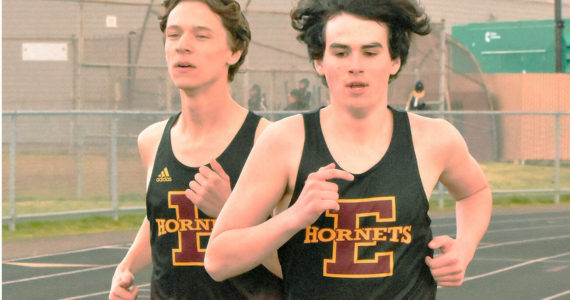 Enumclaw High's Trevor Storm (left) and Evan Cheney ran a strong 800 meters during the Hornets' home meet last week against Clover Park. In the end, Cheney won with a time of 2:11.8, just a stop ahead of Storm's 2:12.0. Both were more than 10 seconds ahead of the third-place finisher, helping EHS to a league victory over the Warriors. Photo by Kevin Hanson