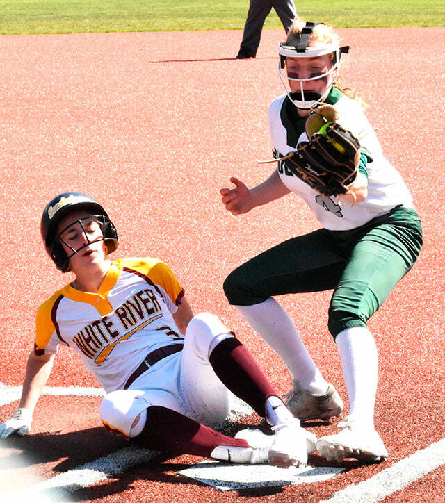 White River’s Kennedy Selander sliding safely into home, scoring a run against Port Angeles. Photo by Kevin Hanson