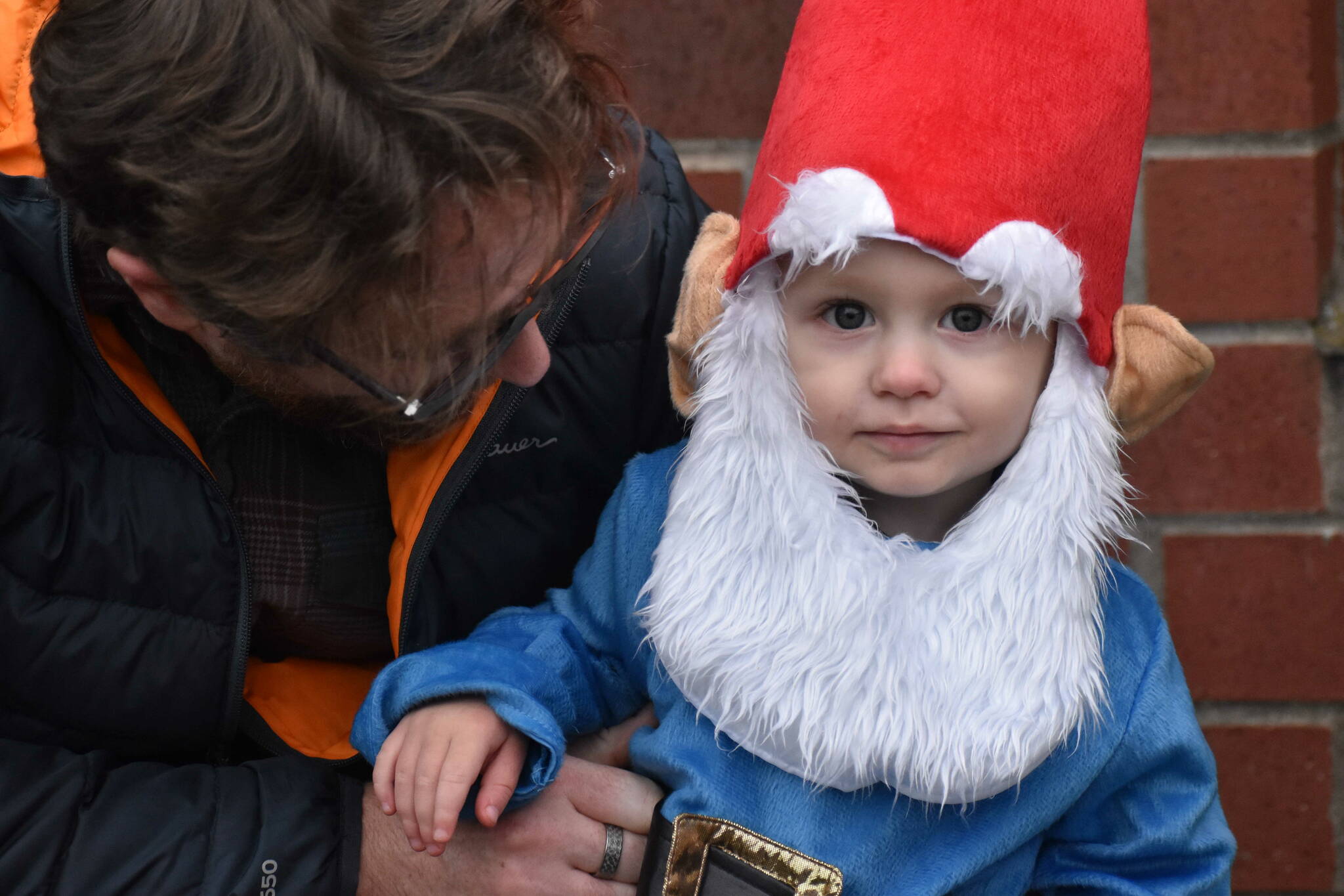 Henrik Huff, 20 months old and dressed as a garden gnome, didn’t appear to cast any spells on Halloween, but he posed for a picture here with dad Matthew Huff. Photo by Alex Bruell.