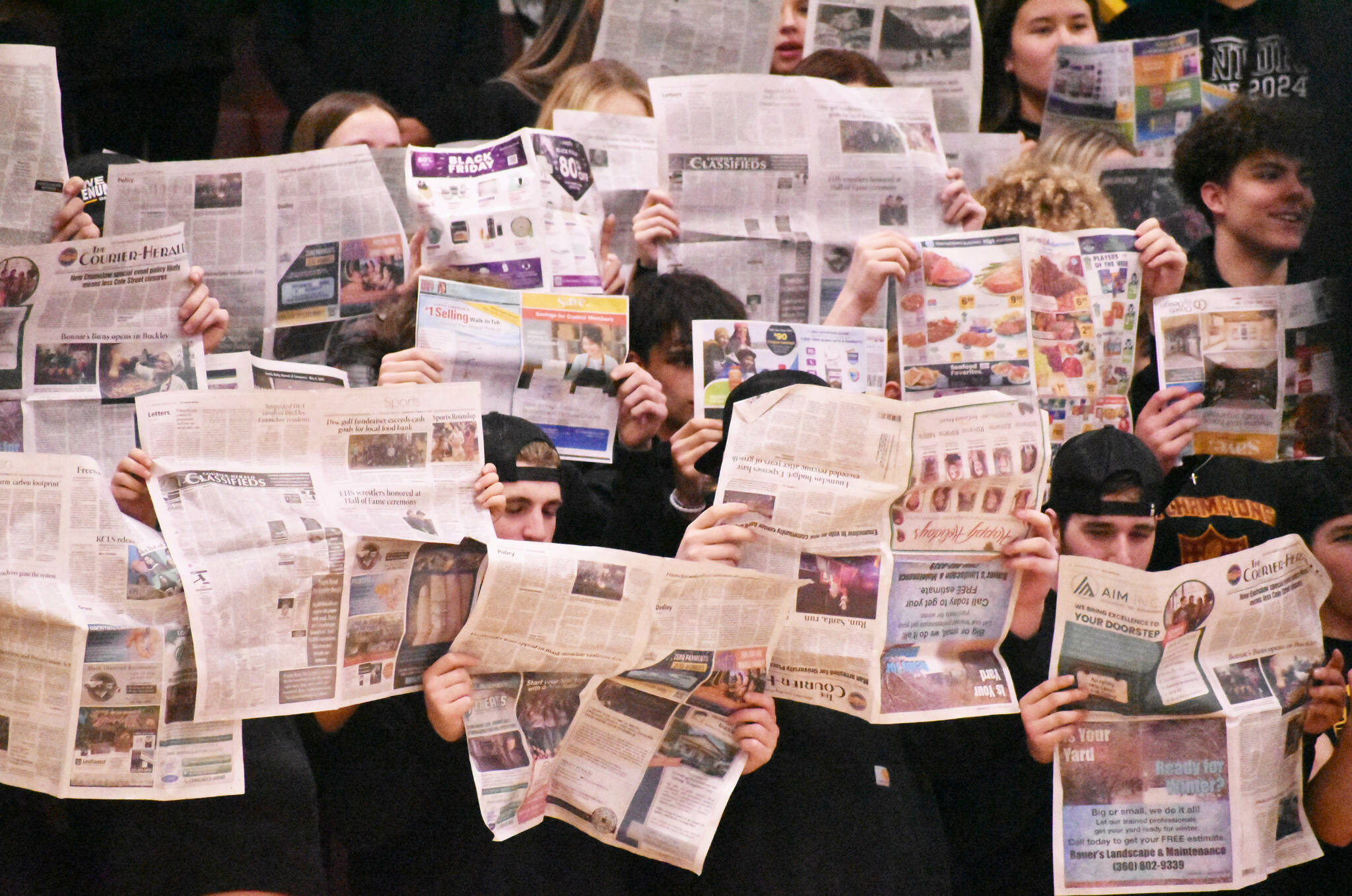 Photo by Kevin Hanson
Don’t let anyone tell you no one reads the paper — EHS students held up the Courier-Herald when the White River basketball team was introduced during the Jan. 9 Battle of the Bridge game. Too bad White River had the last laugh, beating the EHS Hornets 51-46.