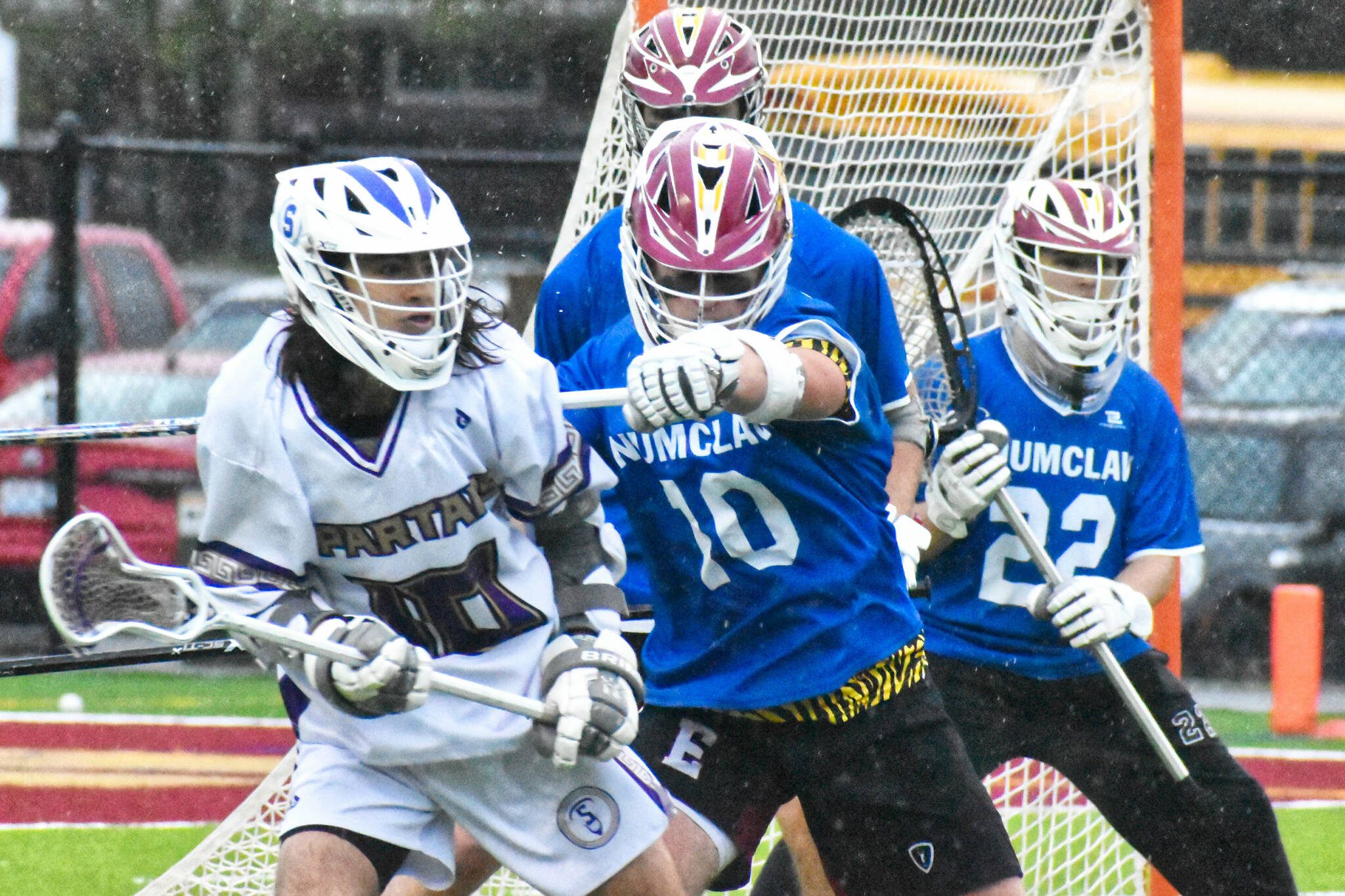 Enumclaw High’s lacrosse team improved to 11-3 overall with a Thursday night victory over the visiting Sumner Spartans. The nonleague contest saw the Hornets jump on top early and coast to a 17-10 win. Success is nothing new to the the Enumclaw crew that captured a Class 2A/1A state title a season ago. Pictured here is defenseman Anthony Mills (10) keeping a Spartan off the attack. For game information about lacrosse (and other spring sports) see the Sports Roundup. Photos by Kevin Hanson