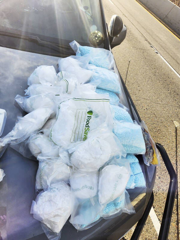 Meth and pills displayed on a hood of a car from a major drug bust that included nine South King County residents. COURTESY PHOTO, U.S. Department of Justice
