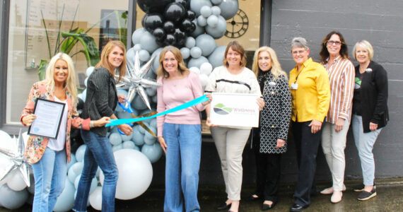 Chamber of Commerce Executive Director Kerry Solmonson, Rainier Foothills Wellness Foundation Executive Director Sara Stratton, Program Coordinator Deanna Kuzaro, Board Vice President Tammi Voorhees, Treasurer Pat Kollen, President Suzanne Lewis, Elaine Parks, and Becky Olness celebrate the nonprofit’s new location on Griffin Avenue with a ribbon cutting. Photo by Ray Miller-Still